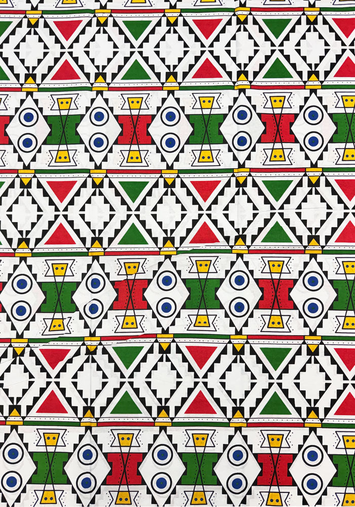 a repeating geometric design with red, green, blue, yellow, and black shapes on a white background.
