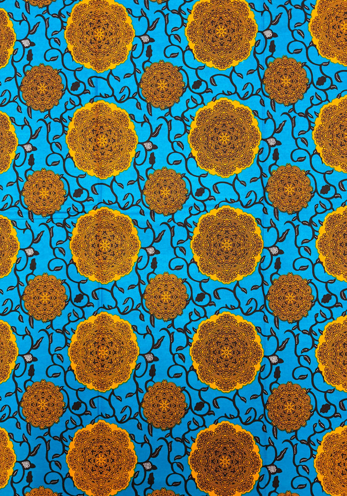 style pattern with large mustard-yellow circular medallions and smaller matching motifs on a bright turquoise blue background, overlaid with dark navy swirling vine details