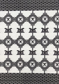 Black and white patterned fabric featuring a repeating geometric design with circular motifs and stylized central symbols, bordered by dense concentric circle bands at the top and bottom.