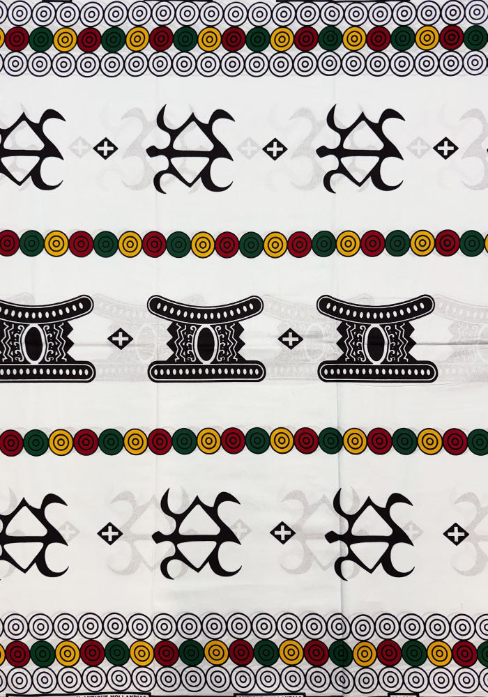 a patterned textile or wallpaper featuring horizontal bands of black tribal-style symbols, green and gold circular dots, and white spiral motifs on a light background.